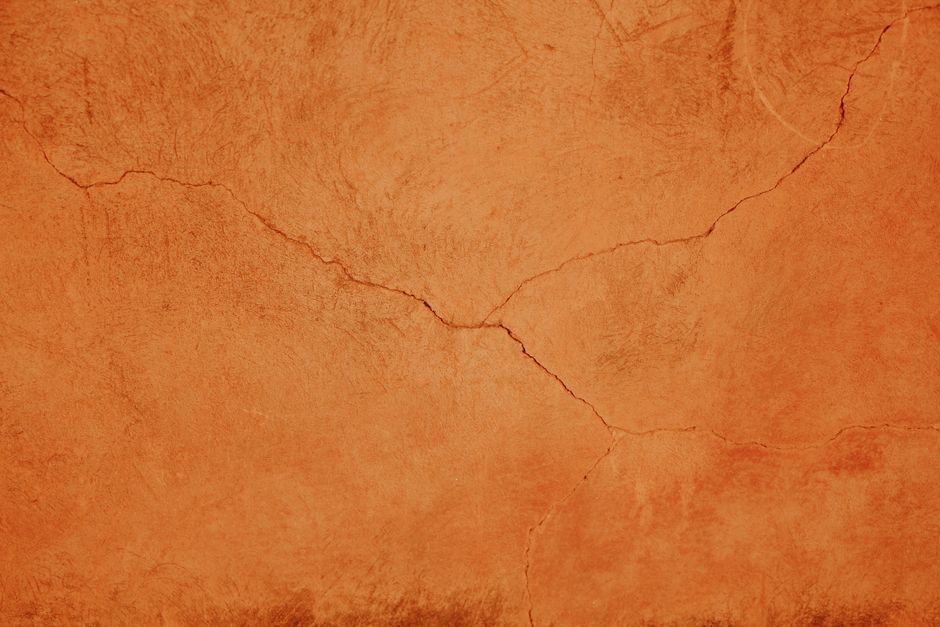 Close-up of a cracked terracotta texture, ideal for backgrounds and design projects.
